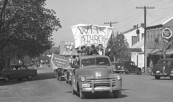 Students parade through town with signs on vehicles protesting the school board's decision not to recognize daylight savings time in 1953. (Bob Voris photo)