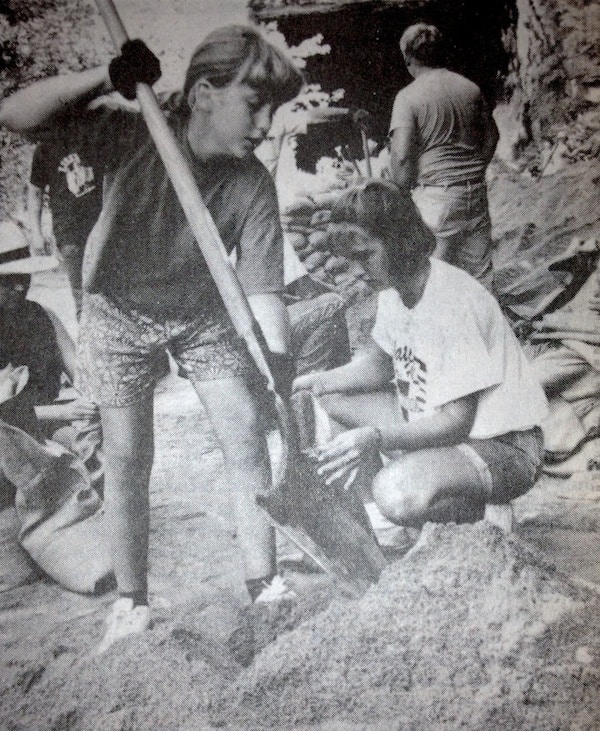 This is a photo that appeared in the July 21, 1993, edition of the Republic-Times, as the rising Mississippi River was beginning to cause serious flooding issues in the American Bottom -- including sand boils throughout the levee system. Pictured, Megan Schneider, 11, of Valmeyer, and Danielle Patton, 14, of Waterloo, help fill sandbags at the Valmeyer quarry. The Aug. 7 edition of the Republic-Times will feature the second of three articles looking back on the Flood of 1993. The first feature ran in the July 17 edition. (Marvin Cortner photo)