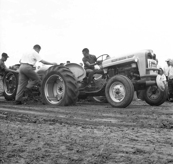 Pictured is a Monroe County Fair tractor pull in 1965, when they used man-weighted sleds during competition -- a stark contrast from today’s motorized sleds. If you can help us name those in the photo, email us at news@republictimes.net. (Bob Voris photo)