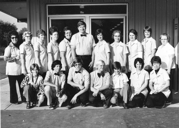 An anchor of old Valmeyer’s business community, Schneider’s celebrated the opening of its expanded new building in 1977 with employees, from left, back row, Vera Pflasterer, Violet Meyer, Joyce Hern, Cecelia Vogt, Mildred Taake, owners Clayton and Jeanette Schneider, Alberta Hohnbaum, Charlotte Knobloch, Gertie Seidler and Leona Knobloch: front row: Dana Schneider, Jim Prange, Joe Schneider, Dennis Knobloch, Mike Schneider, Judy Tipton and Rayma Rippelmeyer.  (photo courtesy Clayton Schneider)