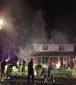Pictured, Columbia firefighters work to extinguish a fire and ventilate smoke Tuesday night at a home on Oak Tree Drive. (Corey Saathoff photo)