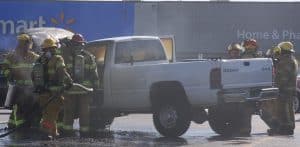 The Waterloo Fire Department quickly doused the flames exuding from Smith's truck in the Waterloo parking lot. (Sean McGowan photo)