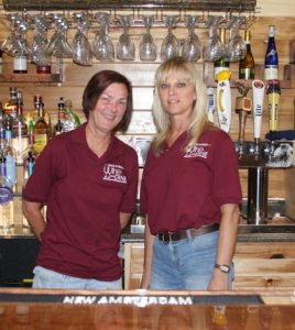 Pictured, from left, are Back Street Wine & Dine co-owners Robbin Layton and Kim Koesterer. They received help from friends and family in designing the bar, and Koesterer designed the wine racks behind the bar. (Sean McGowan photo)