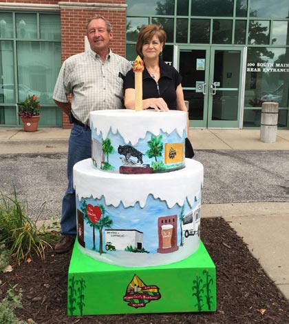 Monroe County Commissioner Delbert Wittenauer and artist Mary Biby stand by the first of two fiberglass cakes that will be on display as part of the Monroe County Bicentennial.