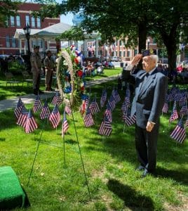 Waterloo American Legion Commander Roy J. May raises his right hand to offer a solemn salute at a ceremonial wreath representing fallen soldiers during Monday’s Memorial Day program outside the courthouse.