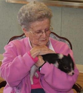 Crystal Weber’s pig Pumba made a special appearance at the fitness day event to brighten residents’ days. Billie Eichenseer cradles Pumba in her arms with an adoring smile on her face.