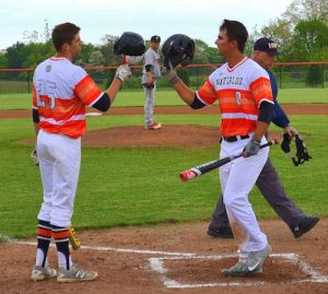 From left, Tyler McAlister and Jordan McFarland celebrate following a McFarland home run this season at home against Triad. (submitted photo) 
