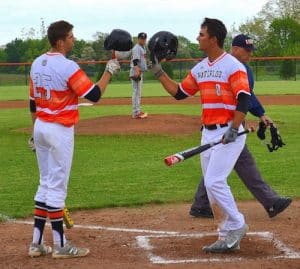From left, Tyler McAlister and Jordan McFarland celebrate following a McFarland home run this season at home against Triad. (submitted photo)