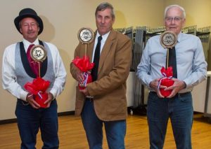 Pictured during Saturday's reenactment, Monroe County commissioners Delbert Wittenauer, Terry Liefer and Bob Elmore display bronze grave markers that commemorate the original county board members, known then as gentlemen judges. Their names are Caldwell Cairns, James Lemen and Abraham Amos. (Alan Dooley photo)