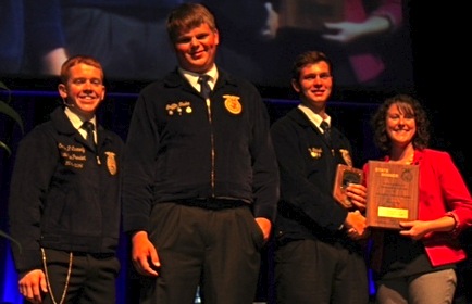 State FFA Vice President Connon Carmondy presents the Student Development award to J.D. Steibel and Griffin Taake with GROWMARK representative Amie Hasselbring. (submitted photo)