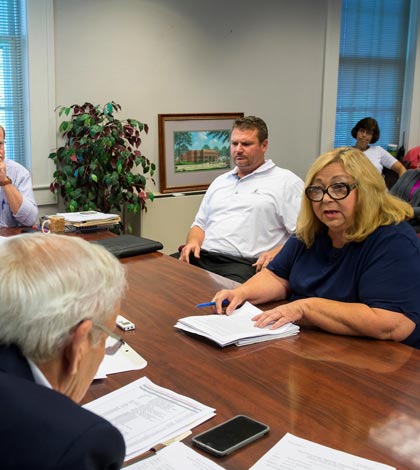 Monroe County Democratic Committee Chairman Jeannine Belt (far right) addresses the Monroe County Board on Tuesday about political campaign signs that continue to provide a source of contention between county Democrats and Republicans. Seated next to Belt is Chad Goldschmidt. (Alan Dooley photo)