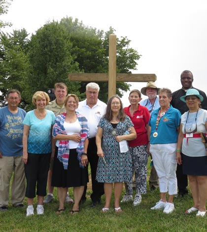 Pictured with Michael Rebholz are individuals representing organizations who assisted with the Potter’s Field project, from left, Ralph Axe, who made the cross with his son Jeff; Norma Reheis, president of the Monroe County History Museum; Rebholz; Barb Buchanan of Whiteside Station Chapter Daughters of the American Revolution; Waterloo Mayor Tom Smith; Sue Watters and Florence Mulligan of DAR; Rev. James Watson of St. Paul United Church of Christ in Waterloo, Pat Vaseska of DAR and the Monroe County Genealogy Society; Father Osang Idagbo of Ss. Peter & Paul Catholic Parish; and Rev. Thelma Burgonio-Watson of the House of Neighborly Service. (Andrea Saathoff photo)