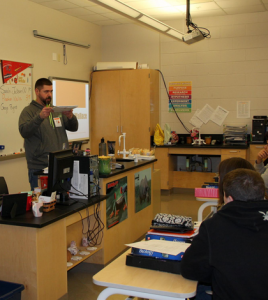 J.R. Wallace demonstrates to biology students at Waterloo High School the science behind his fight with cancer during a visit this past spring. (Kermit Constantine photo)