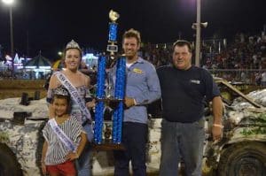 Pictured, Alex Voelker of Waterloo and his passenger, Ed Hesch, pose with the first place trophy in the semi stock division of Friday's demo derby. (Judy Brinkmann photo)