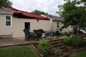 Pictured is the home of Greg and Lisa Clamors on Grand Avenue in Waterloo, after wind lifted and flipped their covered patio onto the roof. (Kermit Constantine photo)