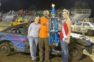 Pictured is Compact Class Figure 8 winner Andy Mercer of Waterloo and passenger Dani Conrad of Columbia with Monroe County Fair Queen Jessica Neary. (Judy Brinkmann photo)