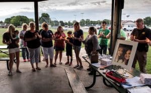 The Liefer and Porter families are joined by friends in remembering Abby Liefer and Hannah Porter during a candlelight vigil held Wednesday night in Red Bud. (Alan Dooley photo)