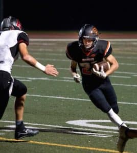 Waterloo's Scott Nanney (right) runs the ball in the second half Friday night against Highland. For more photos from the game, click here. (Alan Dooley photo)