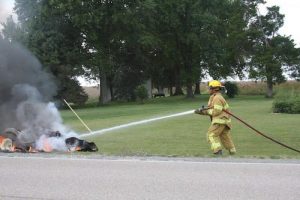 Pictured is a Waterloo firefighter dousing out the lawn mower. (Sean McGowan photo)