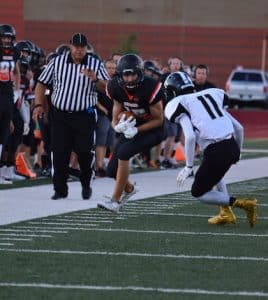 Pictured, senior wide receiver Kyle Knefelkamp eyes the Carbondale resistance as he advances with the ball.