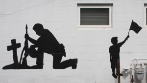 Several Hope Christian Church volunteers added to the patriotic mural on the side of the Edward Jones office building in Waterloo across from JV’s. (Sean McGowan photo)