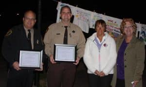 Pictured, from left, peacekeeper award recipients Waterloo Police Chief Jim Trantham and Monroe County Sheriff’s Department Deputy Chad Mueller celebrate with Kay Clements of the Violence Prevention Center in Monroe County and Monroe County Circuit Clerk Sandy Sauget, who helped coordinate Thursday’s Peace Walk in Valmeyer. (Sean McGowan photo)