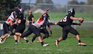 Waterloo's Kory Johnson grabs the jersey of Highland quarterback Garrett Marti on Saturday. (John Spytek photo