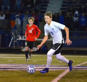 Columbia's Connor Jackson looks to push the ball upfield against Triad on Thursday night. (Corey Saathoff photo)