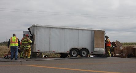 Waterloo firefighters clean up at the scene of the trailer fire. (Sean McGowan photo)