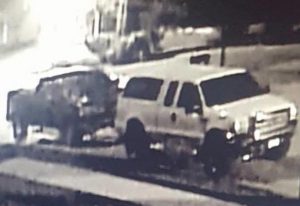 Pictured is a video surveillance still photo of a dark-colored truck believed to be involved in the theft of the white Ford F-250 parked in front of it early Monday morning. (submitted photo)