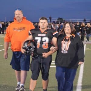 Pictured, WHS senior football player David Woodall escorts his parents onto the field during a pre-game senior night ceremony on Oct. 14. (Corey Saathoff photo)