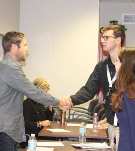 Pictured, Matt Heck, co-owner of Nutshellz, introduces himself to CEO students JD Steibel and Maya Speckhard. (submitted photo)