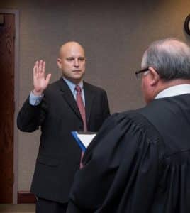 Pictured, Chris Hitzemann is sworn in Dec. 1 as Monroe County State's Attorney by Circuit Judge Dennis Doyle.