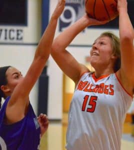 Pictured, Waterloo's Kat Finnerty goes up for a shot against Valmeyer's Blair Brady during the first quarter of the Candy Cane Classic at Gibault on Monday. (Corey Saathoff photo)