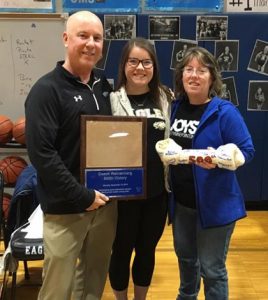 Columbia Middle School basketball coach Jon Wehrenberg is honored for achieving 500 wins with his daughter, Lynsey, and wife, Laurie. (Sean McGowan photo)