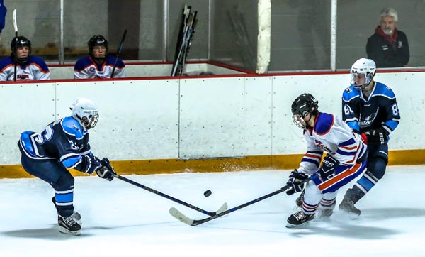 Pictured, Columbia and Freeburg-Waterloo players converge on the puck during the Nov. 10 game won by the Raging Bulldogs. The rivals will meet again this coming Tuesday night in Granite City. (Greg Stanek photo)