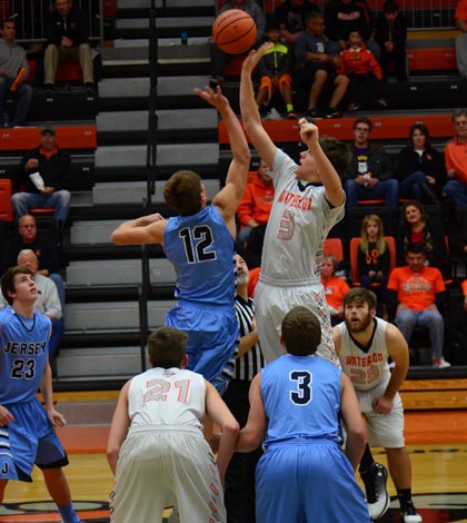 Pictured at right, Waterloo's Dylan Hunt jumps for the ball at the start of the game against Jerseyville on Dec. 2. (John Spytek photo)