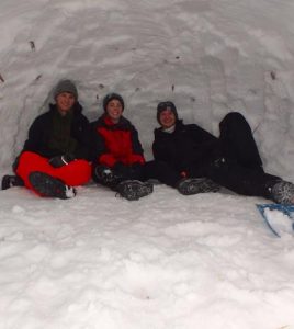 Some scouts on the winter trip to the Rocky Mountains slept in a snow shelter known as a quinzhee. Pictured, from left, Alex Nobbe, Joe Busch and Andrew Durrer kick back and relax inside the makeshift shelter. (submitted photo)