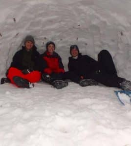 Some scouts on the winter trip to the Rocky Mountains slept in a snow shelter known as a quinzhee. Pictured, from left, Alex Nobbe, Joe Busch and Andrew Durrer kick back and relax inside the makeshift shelter. (submitted photo)