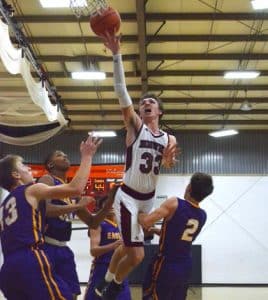 Surrounded by four Civic Memorial defenders, Gibault's Trevor Davis puts up a shot in the lane late in Saturday's game. The Hawks went on to win, 55-53, behind 18 points from Davis. (Corey Saathoff photo)