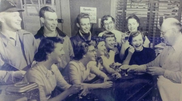 In this picture from the past, Otis "Rex" Rexroth (right), talks with young customers of his store. Pictured, front row, from left, are Joan Eichelmann, Shirley Korves Novack, Jean Kohler Schutt, Elaine Rehmer Carr and Adele Brandt; back row: Herbie Dubois, Leroy Mechler, Frank Martin, Jean Fridrichs Seigfried and Maggie Hempe. (submitted photo)