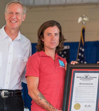 At center, Songs4Soldiers founder Dustin Row of Columbia receives the Illinois Veterans’ Patriotic Volunteer and BUSINESSAppreciation Award from Governor Bruce Rauner (left) and Erica Jeffries of the Illinois Department of Veterans' Affairs at the Illinois State Fair on Sunday. (submitted photo)