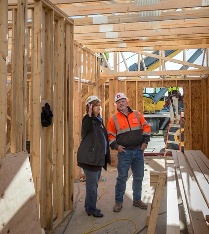 Oak Hill Director Kim Keckritz listens as Holland Construction's Roger Kinzinger explains how interior walls and ceilings will be placed at Evergreen Pointe.