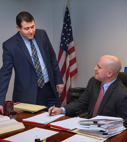 Monroe County Assistant State’s Attorney Ryan Martin (left) and State’s Attorney Chris Hitzemann discuss upcoming cases last week in their office. (Alan Dooley photo)