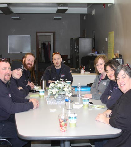 Pictured at Blue Friday Friends with Jan Dudley (far right) of House of Neighborly Service, clockwise, are Monroe County EMS personnel Ryan Weber, Geoff Vogel, Ryan Kaylor and Matt Hill, Monroe County Ambulance Director Carla Heise and Jessica Cutright of Monroe County EMS. (Sean McGowan photo)