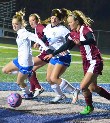 Pictured, Columbia's Kennedy Jones (left) and Gibault's Halle Haudrich (right) go for the ball as Gibault's Kelly Papenberg and Columbia's Reagan Mauch look on in first half action Monday night. (Corey Saathoff photo)