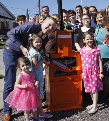 The unveiling of Monroe County’s first registered Little Free Library at St. Paul United Church of Christ in Waterloo on Sunday brought about a new chapter in the community for readers and non-readers alike.
“Last year, I had the idea that I would love to have a Little Free Library in Waterloo,” said Andy Mayer, the brains behind the idea. “Being a reading teacher, spreading my love of literacy has become a passion.”
The Waterloo Junior High School teacher took that inspiration and re-purposed an old newspaper receptacle as a Little Free Library on the church grounds. Such a library allows someone to take a book and either return it or leave a different book in its place.
“The good thing about Little Free Libraries is that there are no late fines,” Mayer said.
Little Free Library is a global organization with a vast number of libraries in Illinois alone. The non-profit’s mission involves “increasing book access and forging community connections,” littlefreelibrary.org states.
“Students have access to books from the school library and the public library, but I wanted an even easier way for them to have access when they are in town,” Mayer concurred. “I also love the idea of a community sharing the experience of reading and lending books to each other.”
The church’s Little Free Library includes a mix of children’s, young adult and adult books with a bench built next to it for people to sit and read. 