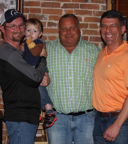 Pictured, from left, new Waterloo school board members Neil Giffhorn (with son Robert) and Jimmy Yaekel celebrate with re-elected school board member Johnny Caupert at Stubborn German Brewing Company on Tuesday night. (Sean McGowan photo)