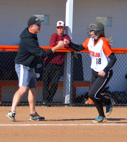 Waterloo head softball coach Matt Mason congratulates Taylor Kaufmann following her two-run home run Friday against Dupo as Tigers head coach Tom Norman looks on.
(Corey Saathoff photo)