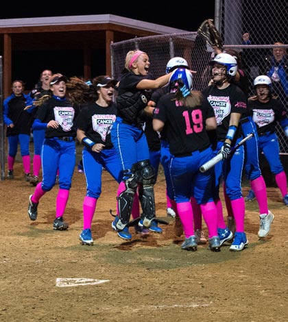 Columbia players celebrate after Calli Wibbenmeyer scores against Waterloo in the title game of Thursday's Monroe County Softball Tournament. For more photos from the tourney, visit www.republictimes.net/photo-store. (Alan Dooley photo)